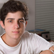 The 18-year-old says continuing to date his high school teacher has prevented him from fully experiencing college life.